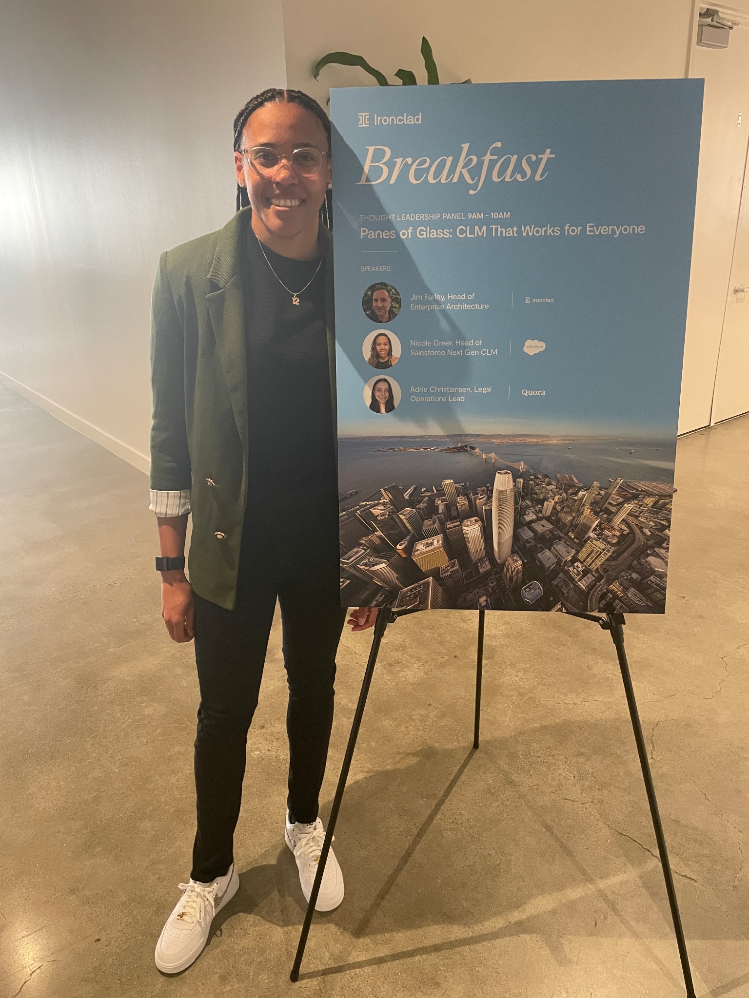 Nicole Greer beside the speaker board for an Ironclad CLM thought leadership breakfast